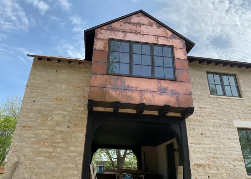 Copper metal panel facade on a stone building for Skylight Installation in Woodmere